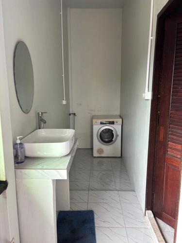 a bathroom with a sink and a washing machine at 1095 - The Pai Pub in Pai