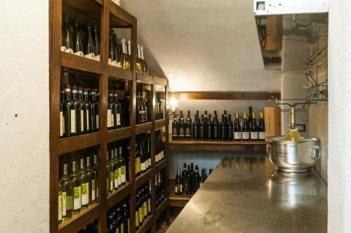 a room filled with lots of bottles of wine at Hotel Overland in Toirano