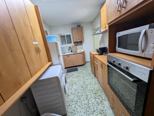 a small kitchen with a microwave and a stove at 1 Bedroom house we call home in Tarshīhā