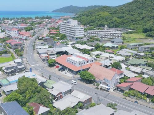 an aerial view of a town with a road at Denpaku Akakina Hotel in Amami