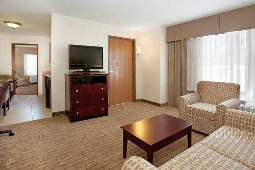 a living room with a couch and a flat screen tv at Holiday Inn Express & Suites Buffalo by IHG in Buffalo