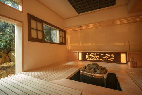 a room with a fireplace in the middle of it at Ochiairo in Izu