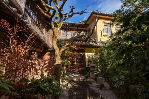 a house with a tree in front of it at Ochiairo in Izu