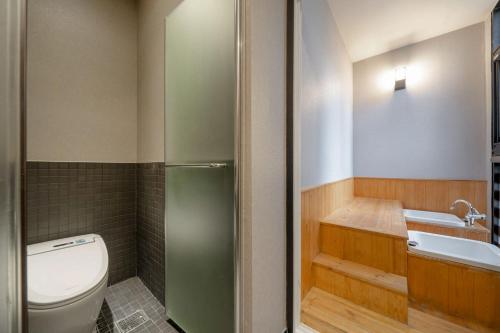 a bathroom with a toilet and a sink at Cheonho Aria Hotel in Seoul