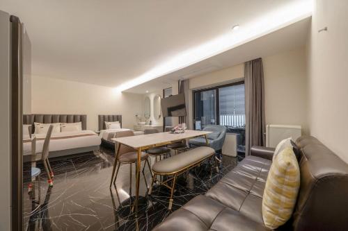 a living room with a couch and a table at Cheonho Aria Hotel in Seoul