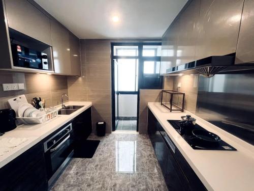 a large kitchen with a sink and a stove at Coral Homes at R&F - free WiFi and 1 Car Park in Johor Bahru