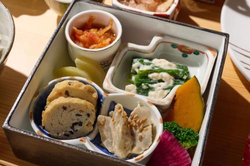 a lunch box filled with different types of food at Ochiairo in Izu