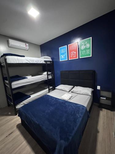 a bedroom with bunk beds and signs on the wall at On Park Hotel e Traslado in Guarulhos