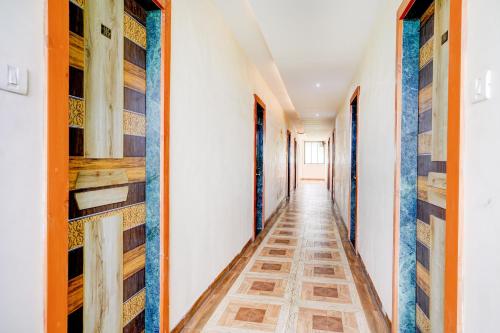 a corridor of a house with wooden shelves at Super Hotel O Kharbao Bhiwandi Thane in Bhiwandi