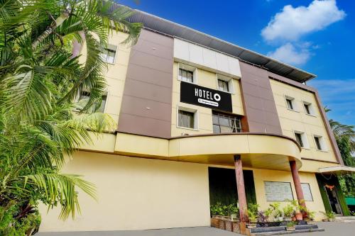 a hotel building with a sign on it at Super Hotel O Kharbao Bhiwandi Thane in Bhiwandi