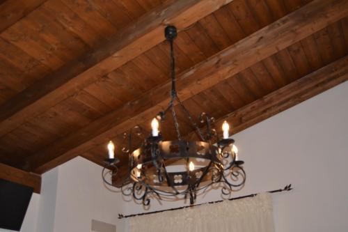 a chandelier hanging from a wooden ceiling at Il Brillocco in Castellabate