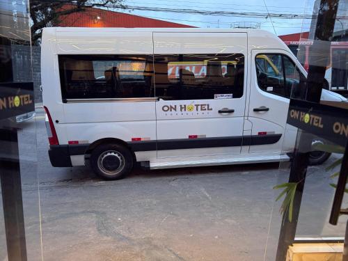 a white food truck parked in a parking lot at On Park Hotel e Traslado in Guarulhos
