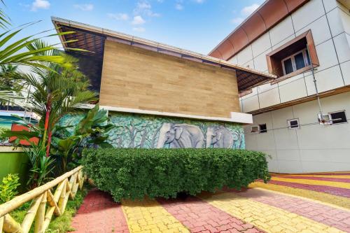 a building with a mural on the side of it at Super Collection O Viyyur Thrissur in Trichūr