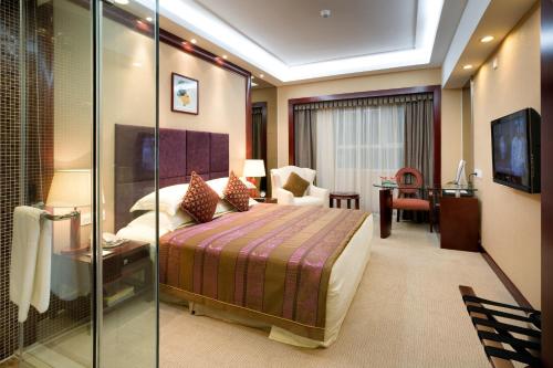 Säng eller sängar i ett rum på Yanling Hotel