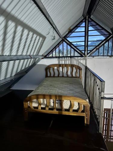 a bed in a room with a large window at Cabaña entre montañas in Paso Ancho