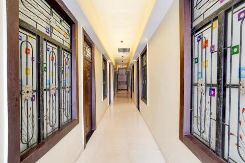 a hallway of a hospital with stained glass windows at Super Hotel O Subedarganj Railway Junction Formerly Krishna Inn in Prayagraj
