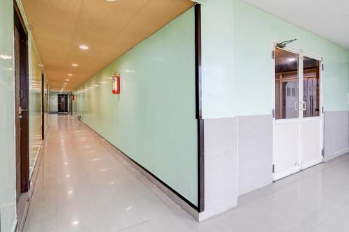 an empty hallway with a large glass wall in a building at Super Collection O Rama Lakshmana Junction Srikakulam in Srīkākulam