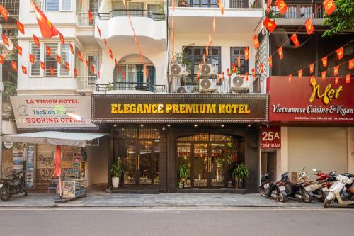a building with motorcycles parked in front of it at Elegance Premium Hotel in Hanoi