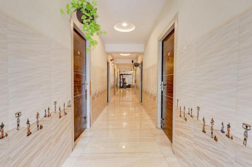 a hallway in a building with a row of keys on the wall at Super Hotel O Eluru Railway Station Formerly Sree Nitya Residency in Elūru