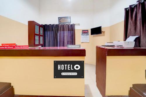 a hotel sign on the counter of a hotel room at Super Hotel O Kunnamangalam Near Bus Stand in Calicut