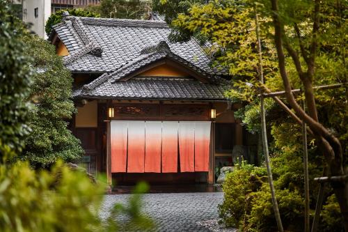 a japanese house with a red door at Ochiairo in Izu