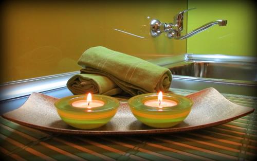 - deux bougies sur un plateau dans une salle de bains avec lavabo dans l'établissement Apartments Vasil Levski, à Plovdiv
