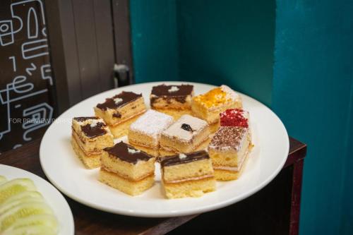 a white plate of desserts on a table at Elegance Premium Hotel in Hanoi