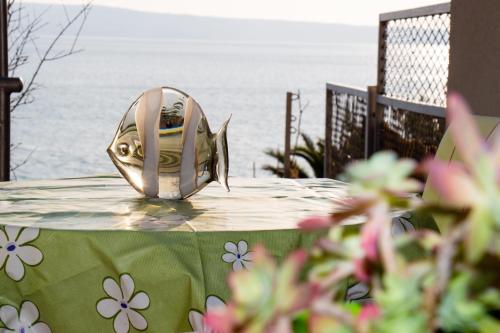 a fish sculpture sitting on a table near the water at Apartment Bava in Jesenice