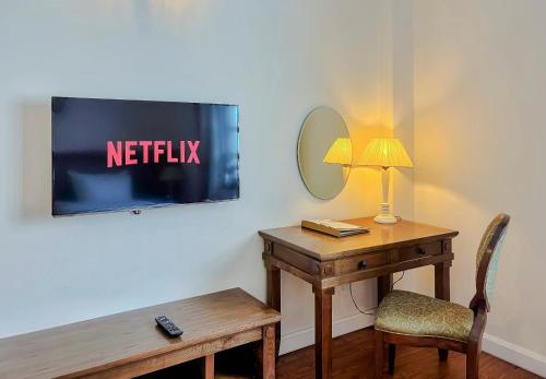 a desk with a lamp and a mirror on a wall at Phoenix Hotel Vung Tau in Vung Tau
