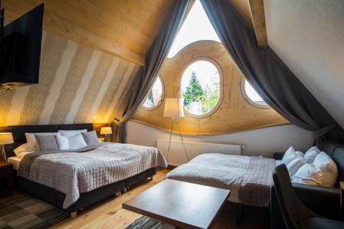 a bedroom with two beds and a window at Villa Belweder in Zakopane