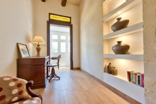 a living room with a desk and a chair at Palazzo Violetta in Sliema