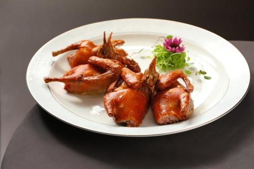 a plate of food with chicken on a table at Holiday Inn Fuzhou Exhibition Center in Fuzhou