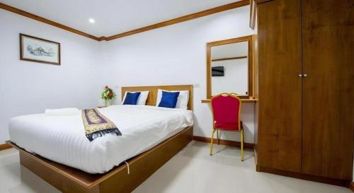 a bedroom with a bed and a red chair at Thatphanom View Hotel Nakhon in Nakhon Phanom