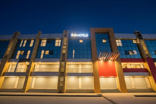 a building with a sign on the front at night at FabHotel Raj Villa - Nr Tri mandir in Jāmb