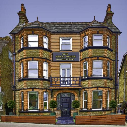 a large brick building with a sign on it at The Guest House Broadstairs in Broadstairs