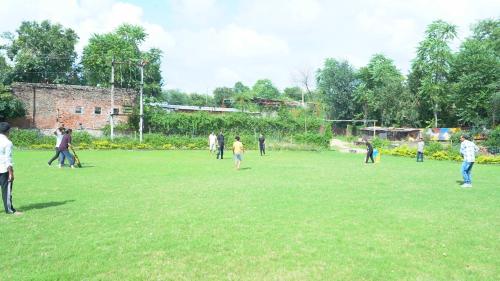 a group of people playing a game in a field at Hari Kamal Guest House And Swimming Pool in Dhānd