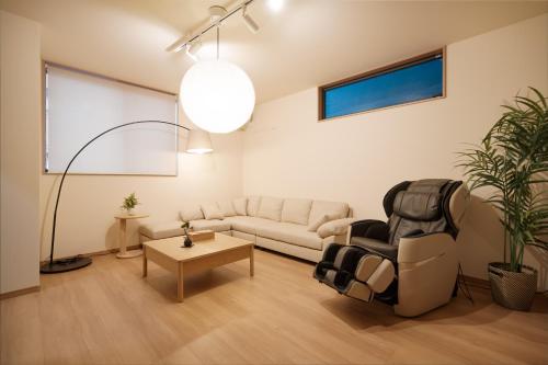a living room with a couch and a table at 静和 旅タイム岸里美楽 in Osaka