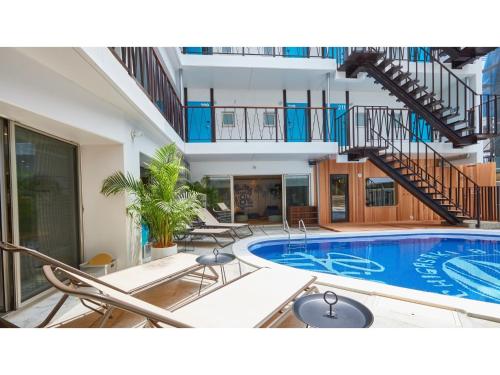 a large swimming pool with chairs and a staircase at 8HOTEL CHIGASAKI - Vacation STAY 87545v in Chigasaki
