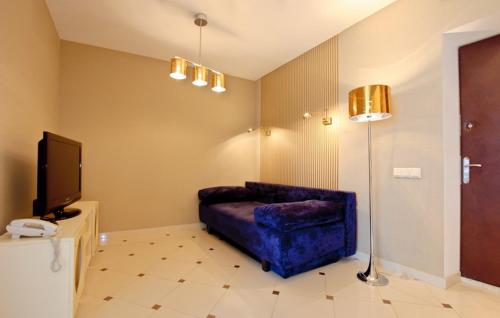 a living room with a couch and a tv at Partner Guest House in Kyiv