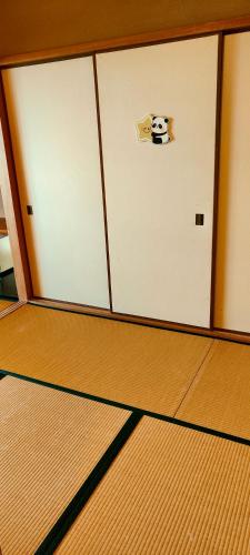 a room with a door with a panda face on it at 和みの宿いろり 甘露の湯付き in Shirahama