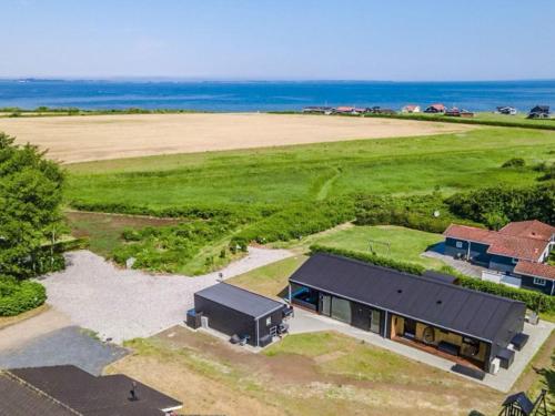 an aerial view of a house with the ocean in the background at 10 person holiday home in Vinderup-By Traum in Vinderup