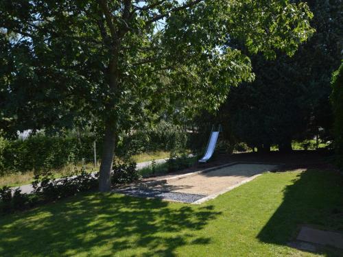 a park with a bench and trees and grass at Holiday Home in Waimes with Sauna & Bubble Bath in Waimes