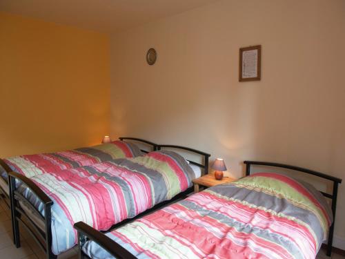 two beds sitting next to each other in a bedroom at Holiday Home in Waimes with Sauna & Bubble Bath in Waimes