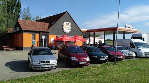 a row of cars parked in front of a gas station at Bed & Parking Eurobit in Hrušky