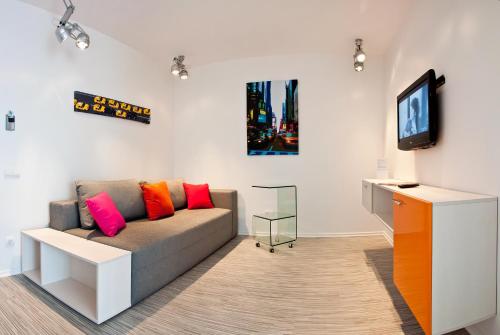 a living room with a couch and a tv at Partner Guest House in Kyiv
