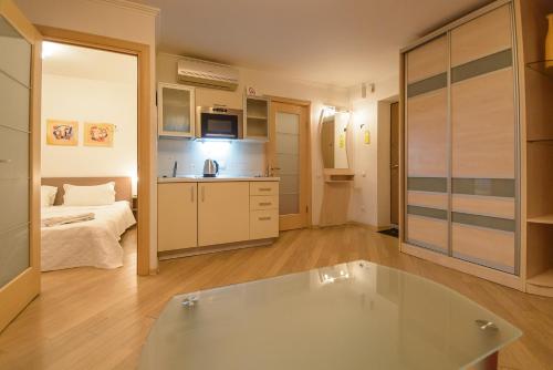 a bathroom with a tub in a room with a bed at Partner Guest House in Kyiv