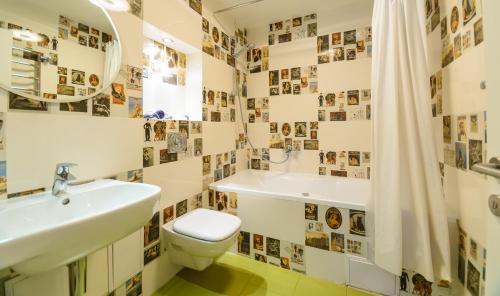 a bathroom with a sink and a toilet and a tub at Partner Guest House in Kyiv