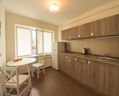 a kitchen with a table and a counter top at Partner Guest House in Kyiv