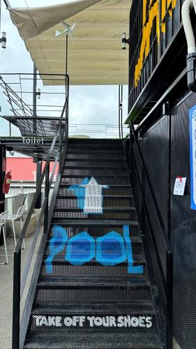 a set of stairs with blue graffiti on it at Jam Hostel Bangkok in Bangkok