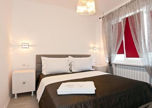 a bedroom with a bed and a red window at Partner Guest House in Kyiv